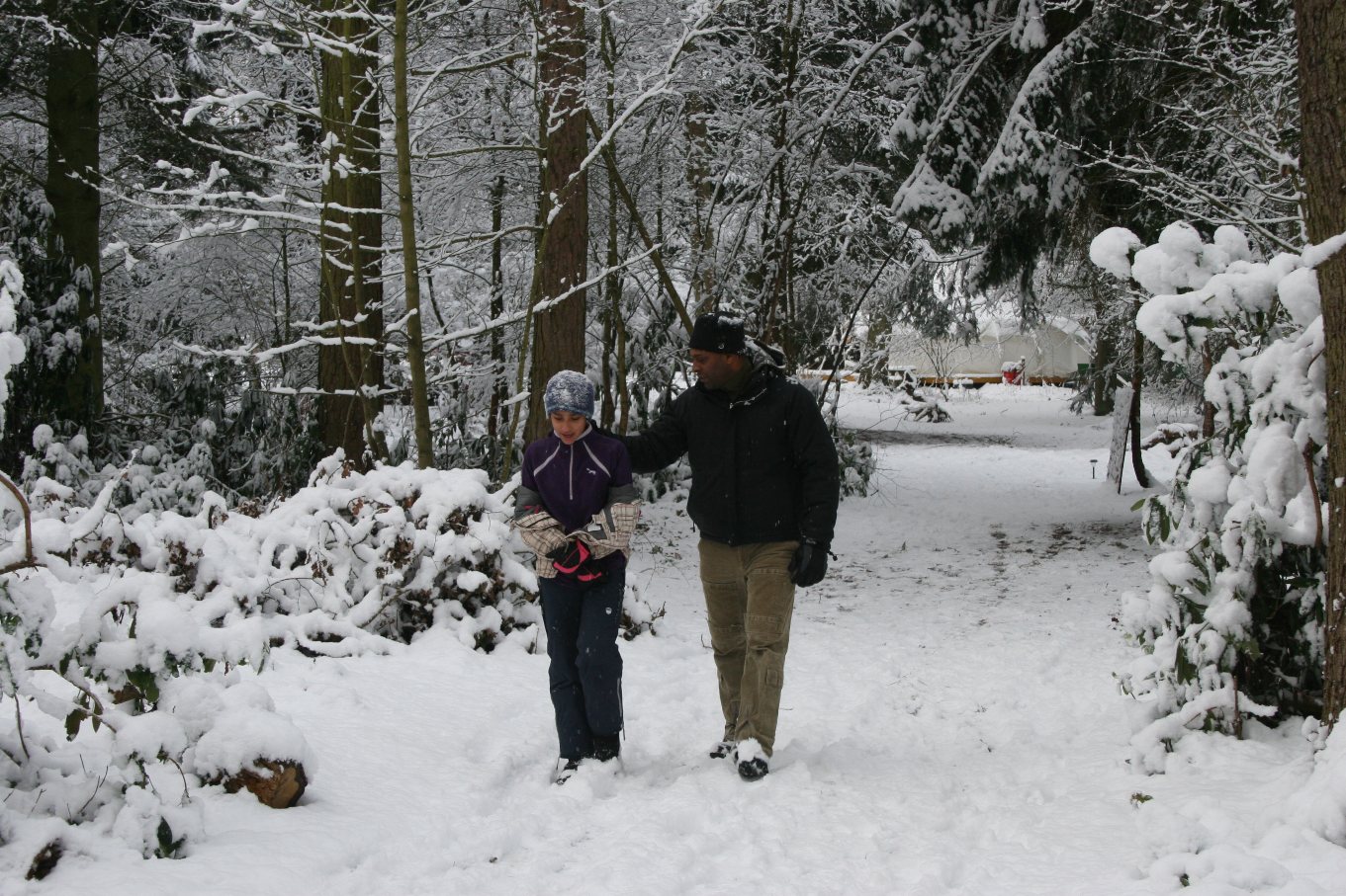 Two people walking in the Northwood Trail in snow