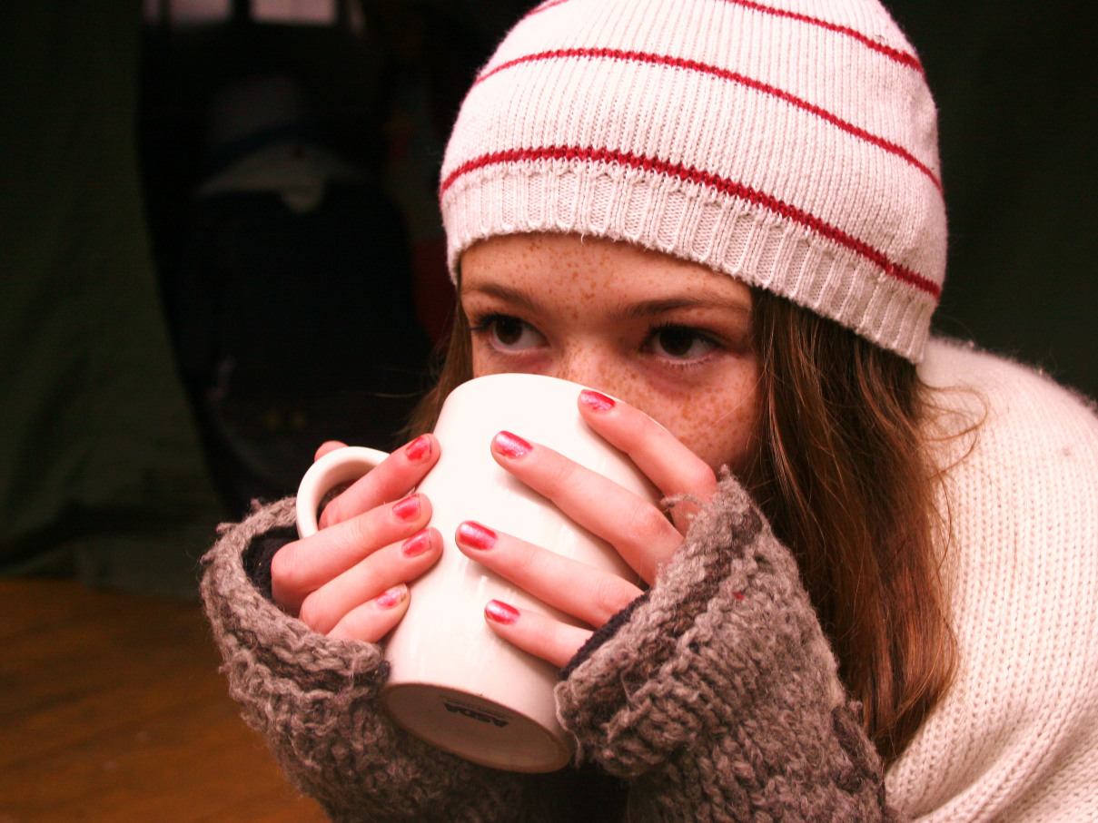 A woman drinking coffee from a mug