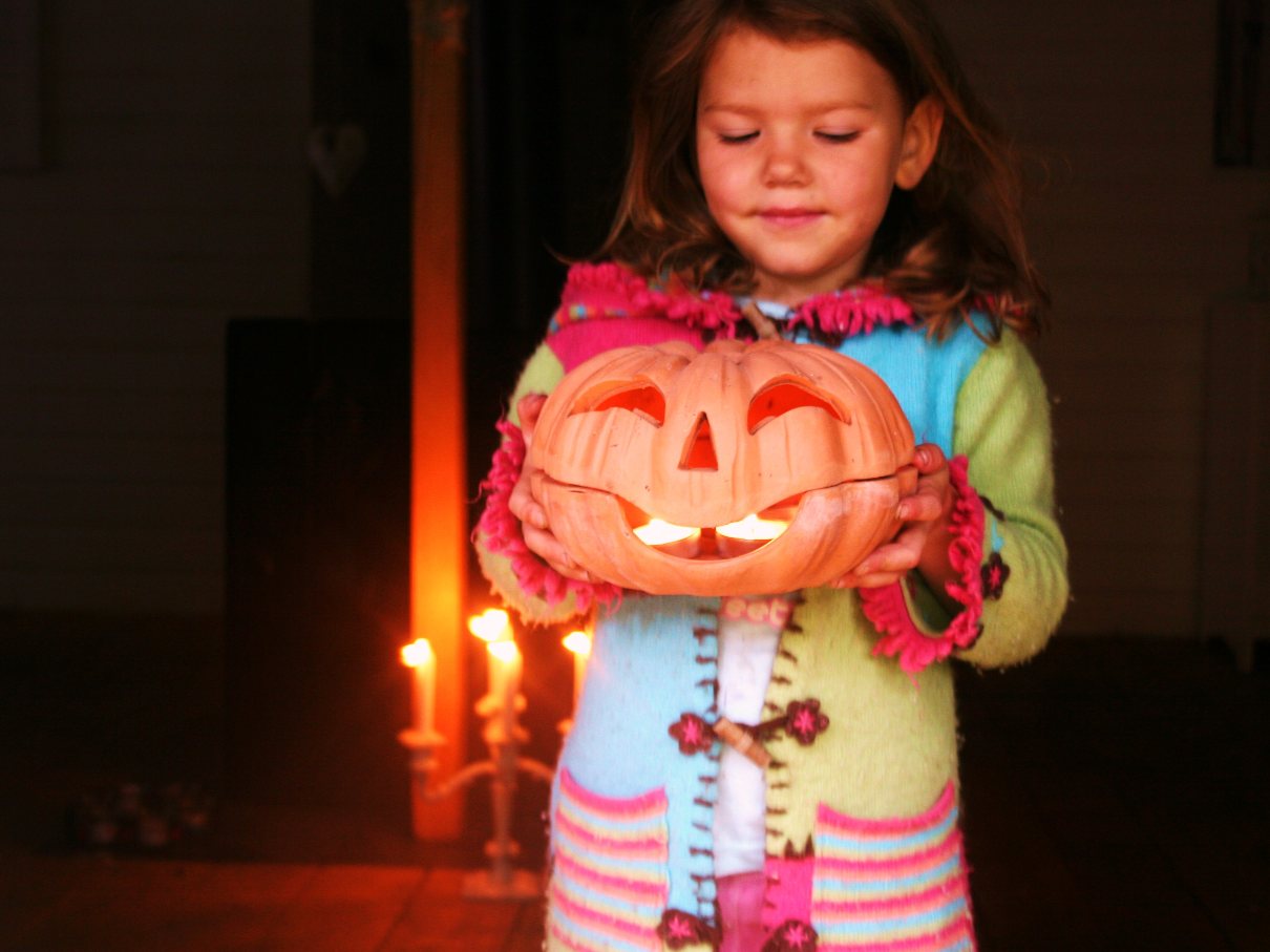 A girl holding a pumpkin